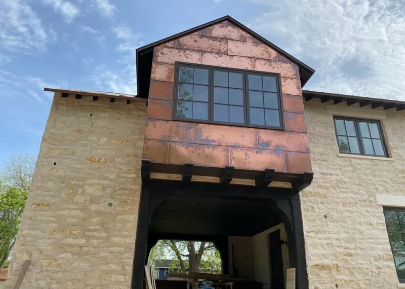 Copper metal panel facade on a stone building for Skylight Installation in Shiloh
